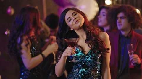 Dancing lady in a sequin dress at stuff party in front of the camera feeling Video stock 144884880