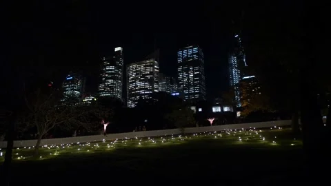 Dancing lights next to Sydney skyscrapers 4K Stock Footage 165577494