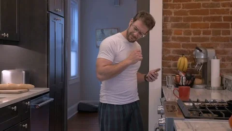 Dancing man on his smart phone while checking email in slow motion Stock Footage 81844346