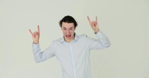 Dancing man makes rock and roll style hand gesture on white background Stock Footage 290847051