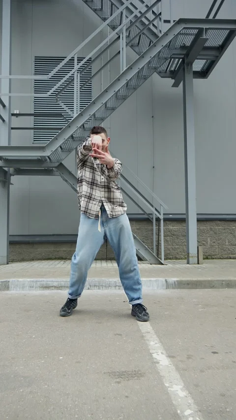 Dancing man outdoors. Creative guy in street style clothes dancing for camera Video stock 310307638