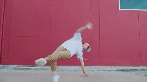 Dancing man performing breakdancing in street wall having fun Stock Footage 150474264