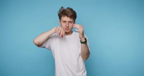 Dancing man shows different moves in a simple setting with a blue background Stock Footage 331990858