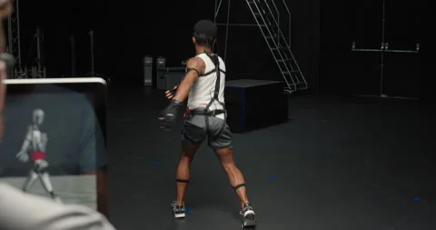 Dancing man wearing motion capture suit in studio actor wearing mo-cap suit for Stock Footage 138391170