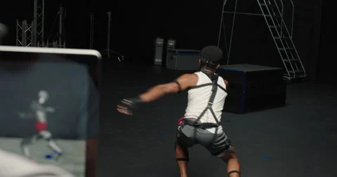 Dancing man wearing motion capture suit in studio actor wearing mo-cap suit for Stock Footage 138391263