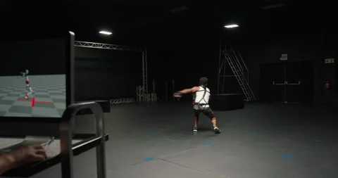 Dancing man wearing motion capture suit in studio actor wearing mo-cap suit for Stock Footage 138391296