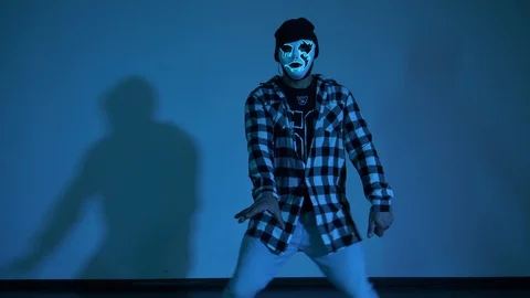 Dancing in mask on blue background Stock Footage 118984474