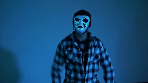 Dancing in mask in interior on blue background 库存影片 119066020