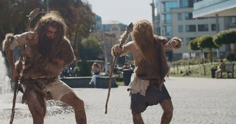 Dancing neanderthals man of hunter-gatherers in animal fur holding prehistoric Stock Footage 118397959