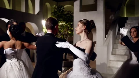 Dancing pairs on dance floor in royal palace in night, medium portrait, slow Stock Footage 247109882