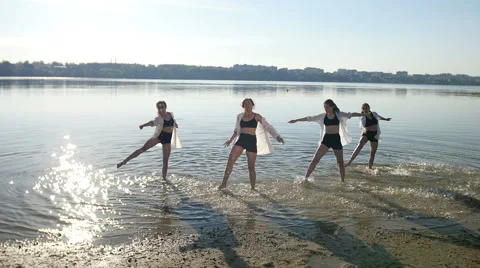 Dancing performance on water of four girls near beach Video stock 65302908