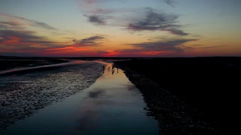 Dancing playing on beach at sunset drone shot Stock Footage 286065614