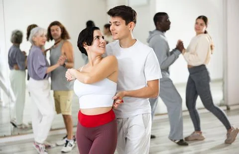 Dancing positive couples learning salsa Stock-Fotos