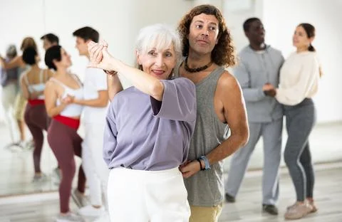 Dancing positive couples learning salsa Stock Photos
