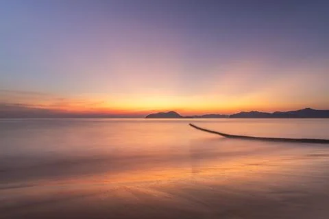Dancing Shadows: Palm Tree Trunk in Sunset's Embrace Stock Photos