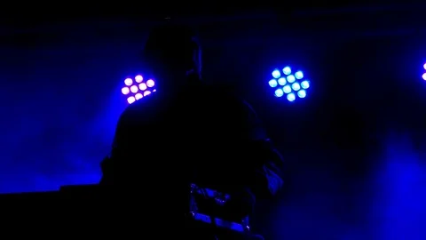 Dancing silhouette DJ performing, neon light, theatrical smoke fog in background Stock Footage 70150562