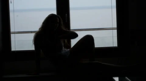 Dancing silhouette in front of a window Stock Footage 62732945