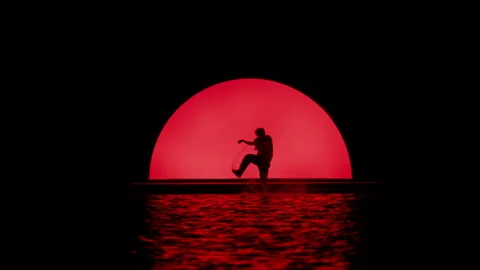 Dancing Silhouette By The Water With Red Light Video stock 255537475