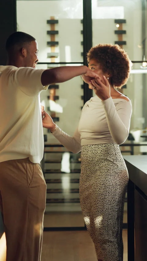 Dancing, spin and couple in kitchen with music for bonding, connection or Stock Footage 340792579