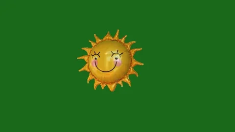 Dancing sun foil balloon moving playfully isolated on green screen. Stock-Footage 345519314
