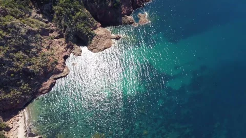 Dancing Sunlight on the Pristine Waters of a Rocky Cove Stock Footage 253543698