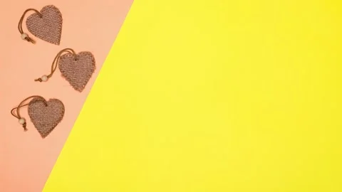 The dancing three hearts on the pink surface seem to be beating passionately. Video stock 149764462