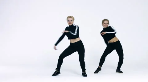 Dancing two girls on a white background in studio. 4K 30fps ProRes (HQ) Stock Footage 66908764