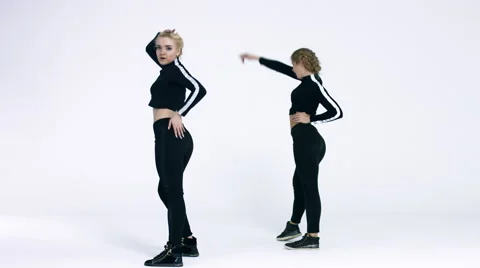 Dancing two girls on a white background in studio. 4K 30fps ProRes (HQ) Video stock 66909111