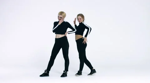 Dancing two girls on a white background in studio. 4K 30fps ProRes (HQ) Video stock 66909331