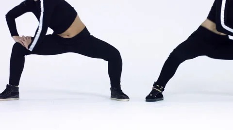 Dancing two girls on a white background in studio. 4K 30fps ProRes (HQ) Video stock 66909772