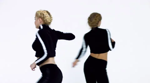 Dancing two girls on a white background in studio. 4K 30fps ProRes (HQ) Video stock 66909917