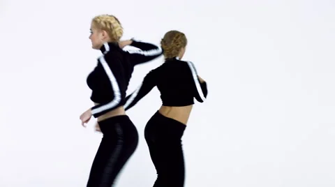 Dancing two girls on a white background in studio Video stock 66910209