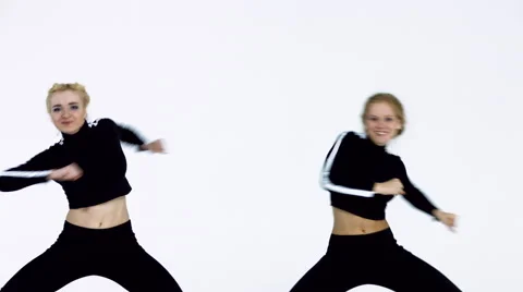 Dancing two girls on a white background in studio. 4K 30fps ProRes (HQ) Video stock 66910333