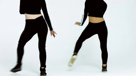 Dancing two girls on a white background in studio Video stock 66910473