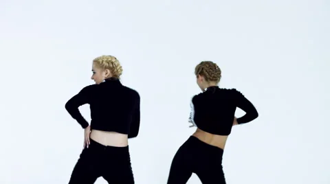 Dancing two girls on a white background in studio Video stock 66910632