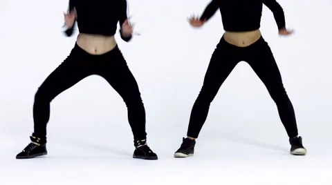 Dancing two girls on a white background in studio. 4K 30fps ProRes (HQ) Video stock 66910749