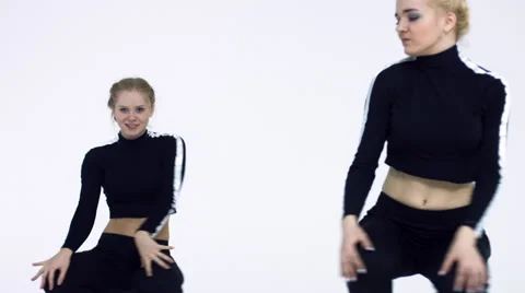 Dancing two girls on a white background in studio Video stock 66910871
