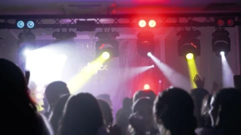 Dancing under the rays of light devices raising your hands up Stock Footage 201181931