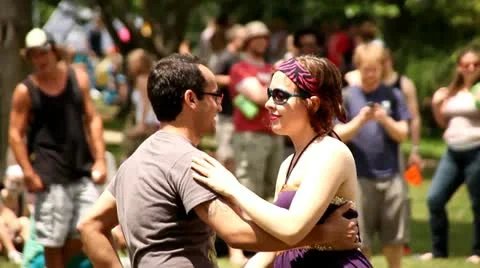 DANCING, YOUNG COUPLE DANCING OUTSIDE AT FESTIVAL Stock Footage 21778793