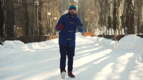 Dancing young man in winter park Stock Footage 72292384