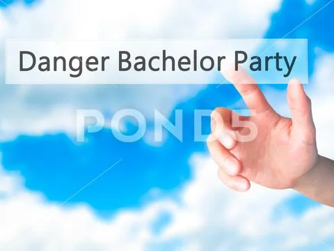 Danger Bachelor Party - Hand pressing a button on blurred backgr Stock Photos