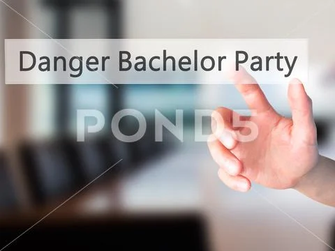 Danger Bachelor Party - Hand pressing a button on blurred backgr Stock Photos