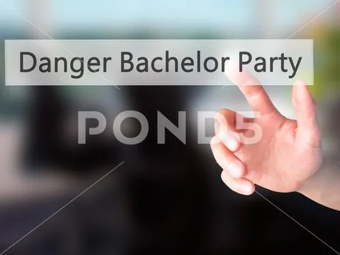 Danger Bachelor Party - Hand pressing a button on blurred backgr Stock Photos