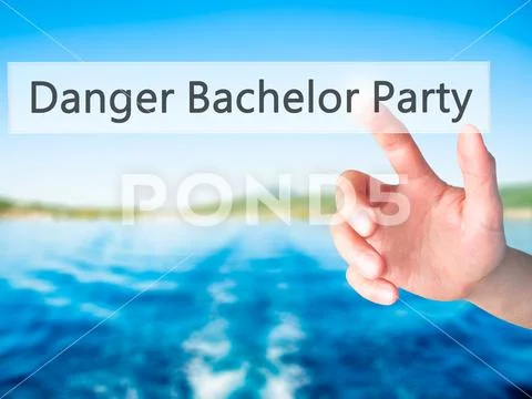 Danger Bachelor Party - Hand pressing a button on blurred backgr Stock Photos