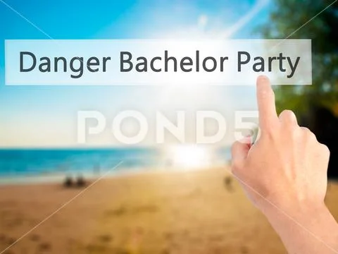 Danger Bachelor Party - Hand pressing a button on blurred backgr Stock Photos