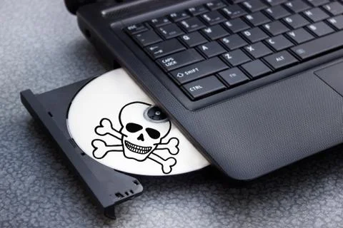Danger CD in tray of computer laptop Stock Photos