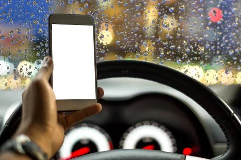 Danger concept man using cell phone while driving in rainy road Stock Photos