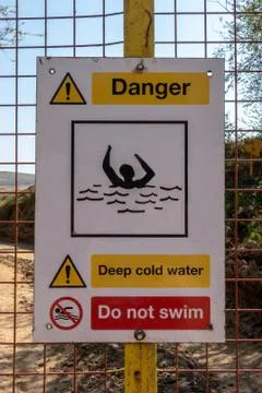 Danger Deep Cold Water warning sign on a quarry gate Stock Photos