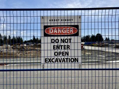 Danger Do Not Enter Open Excavation Warning Sign on Construction Site Fence Stock Photos