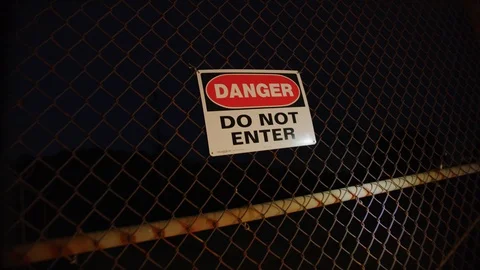 Danger Do Not Enter sign at fence at night Stock Footage 126689298